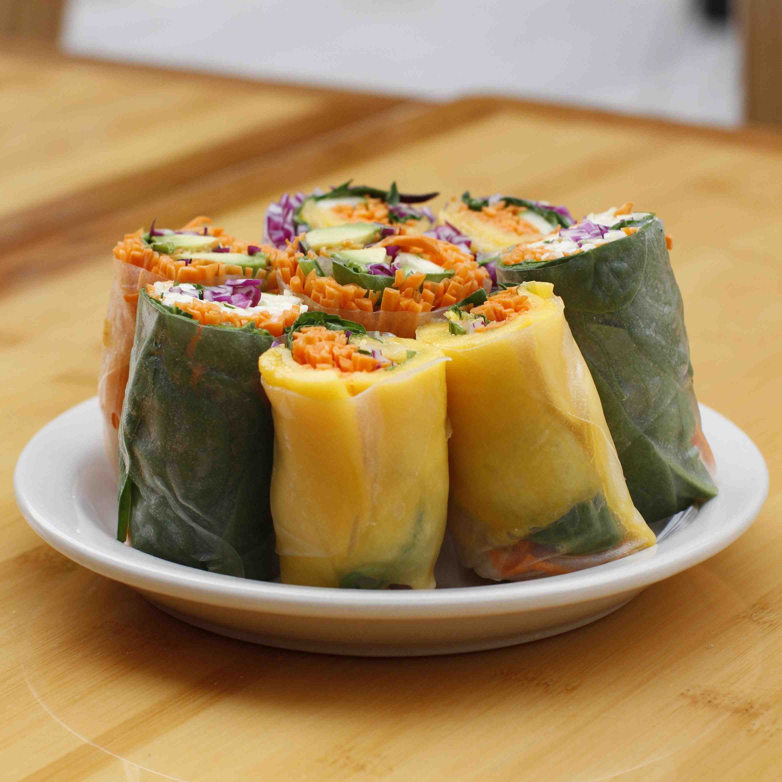 Mango Rolls, made with shredded carrot, red cabbage, cucumber and mango slices in a rice wrapper cut into small bite sized pieces.